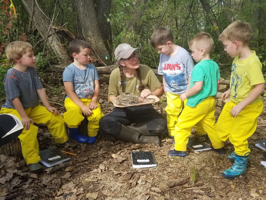 nature prek students exploring bird nest