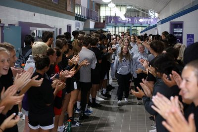 The Goshen College Bowling Team walks through an applause tunnel in the RFC