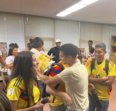 Students hugging in greeting at the LSU Taste of Colombia event