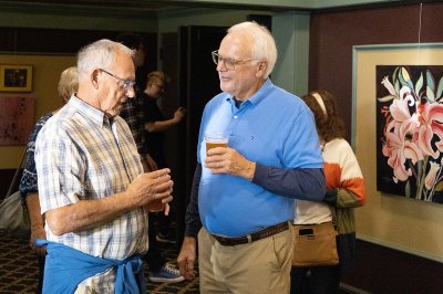 Two friends chat over a Broken Shield beer.