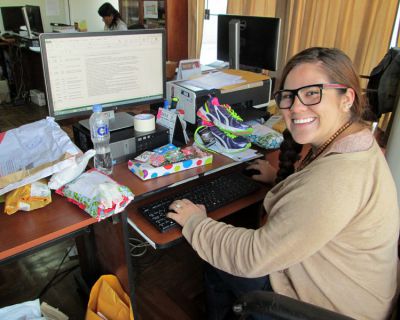 Frances at her desk in the Cusco office of World Vision, surrounded by gifts sponsors have sent to local children.