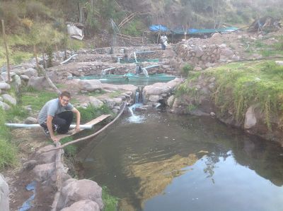 Alberto crouches by a pool of trout.