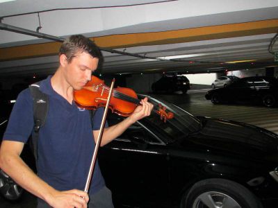 Peter tests out his new, made in China, violin in an underground parking garage in Lima.