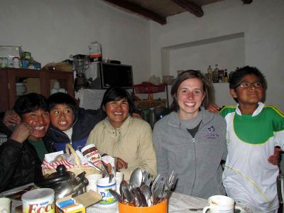 Irene at the table with her host family.