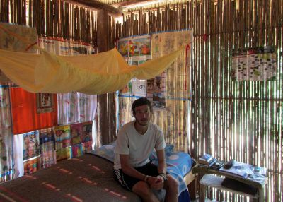 David in his bedroom with mosquito netting.