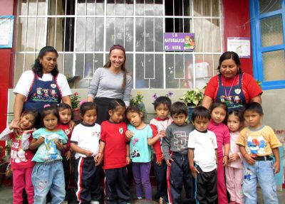 The class poses in the courtyard with their teachers.