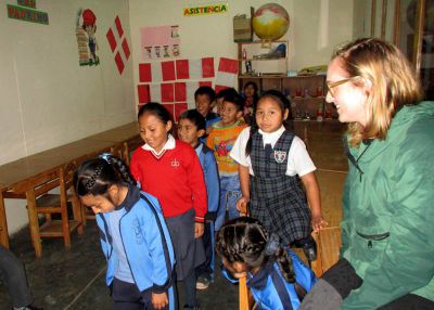 Anna watches children play a game.